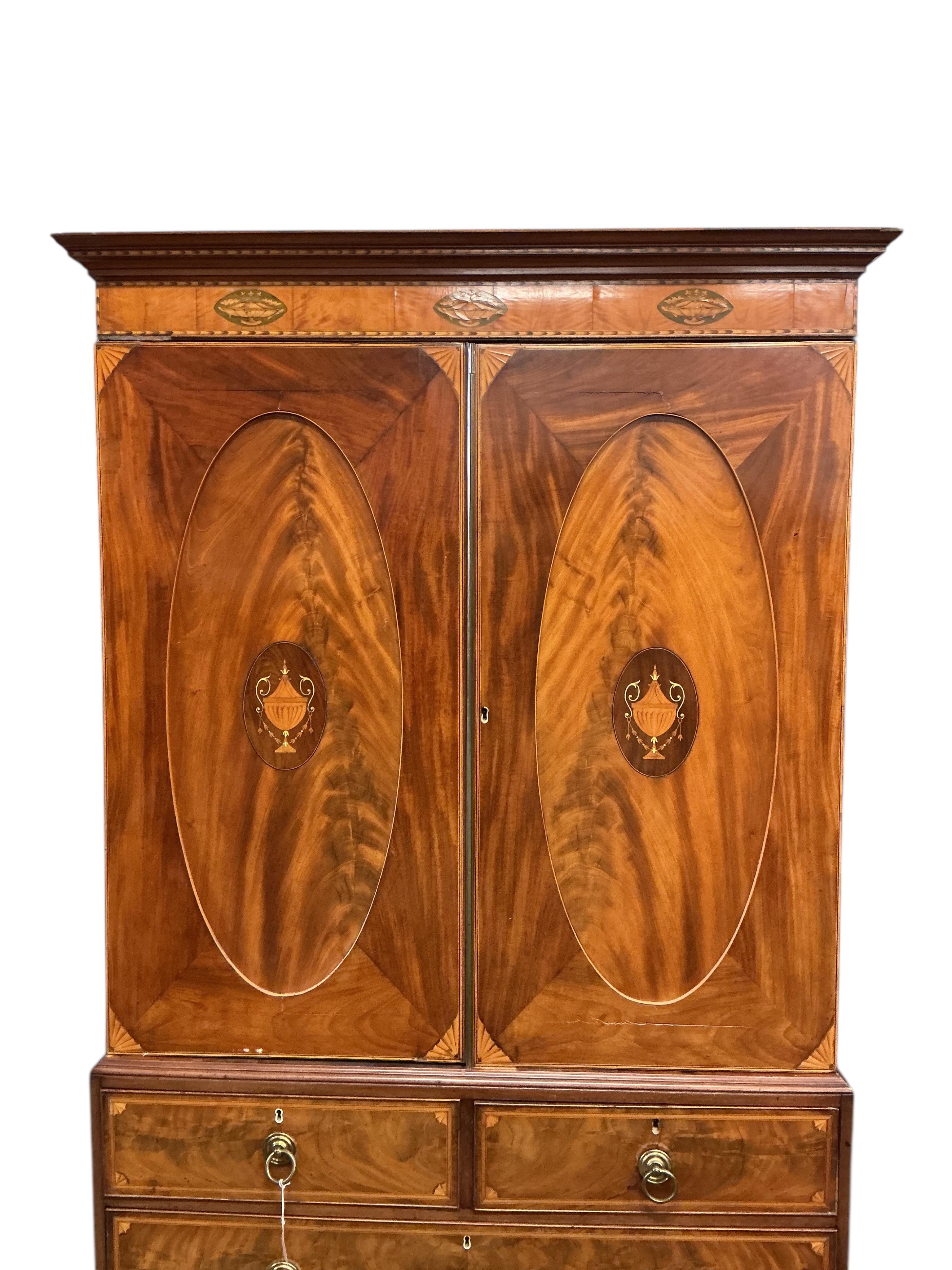 A George IV marquetry inlaid mahogany linen press, width 124cm, depth 60cm, height 223cm